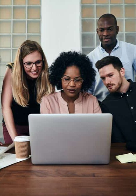 Diverse group looking at laptop